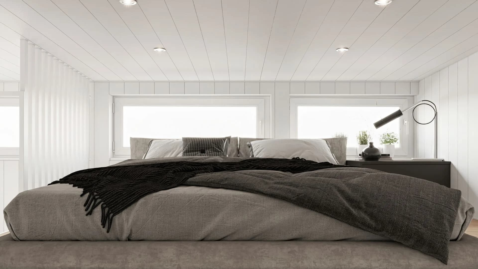 Fritidshus loft med säng och fönster