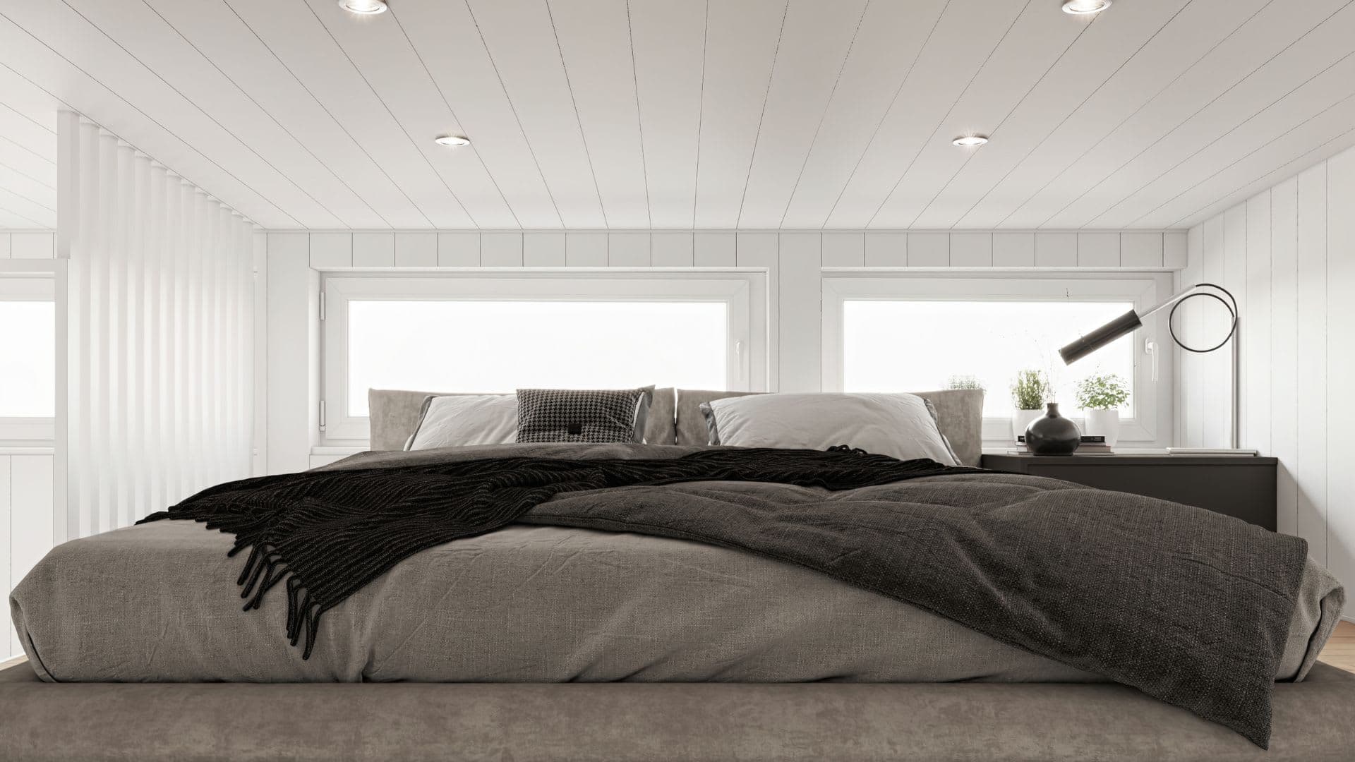 Fritidshus loft med säng och fönster